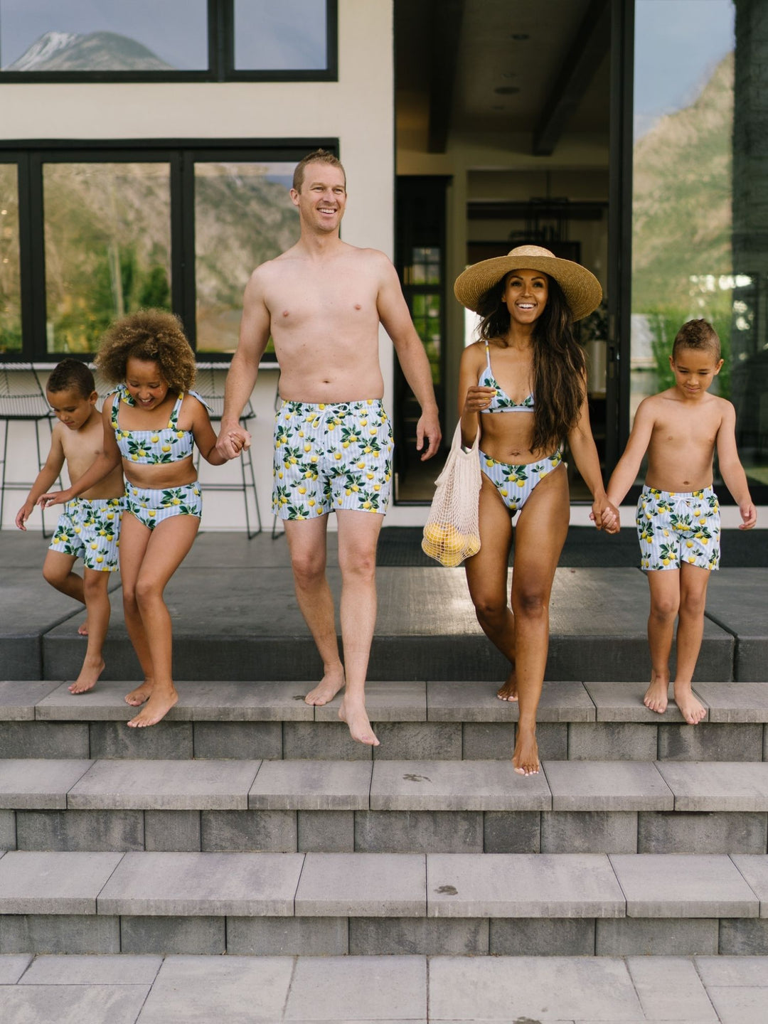 Navalora Swim Boy's Amalfi Coast Inspired Lemon Swim Shorts, Family Wearing Matching Swimsuits Lifestyle Image Walking on Stairs