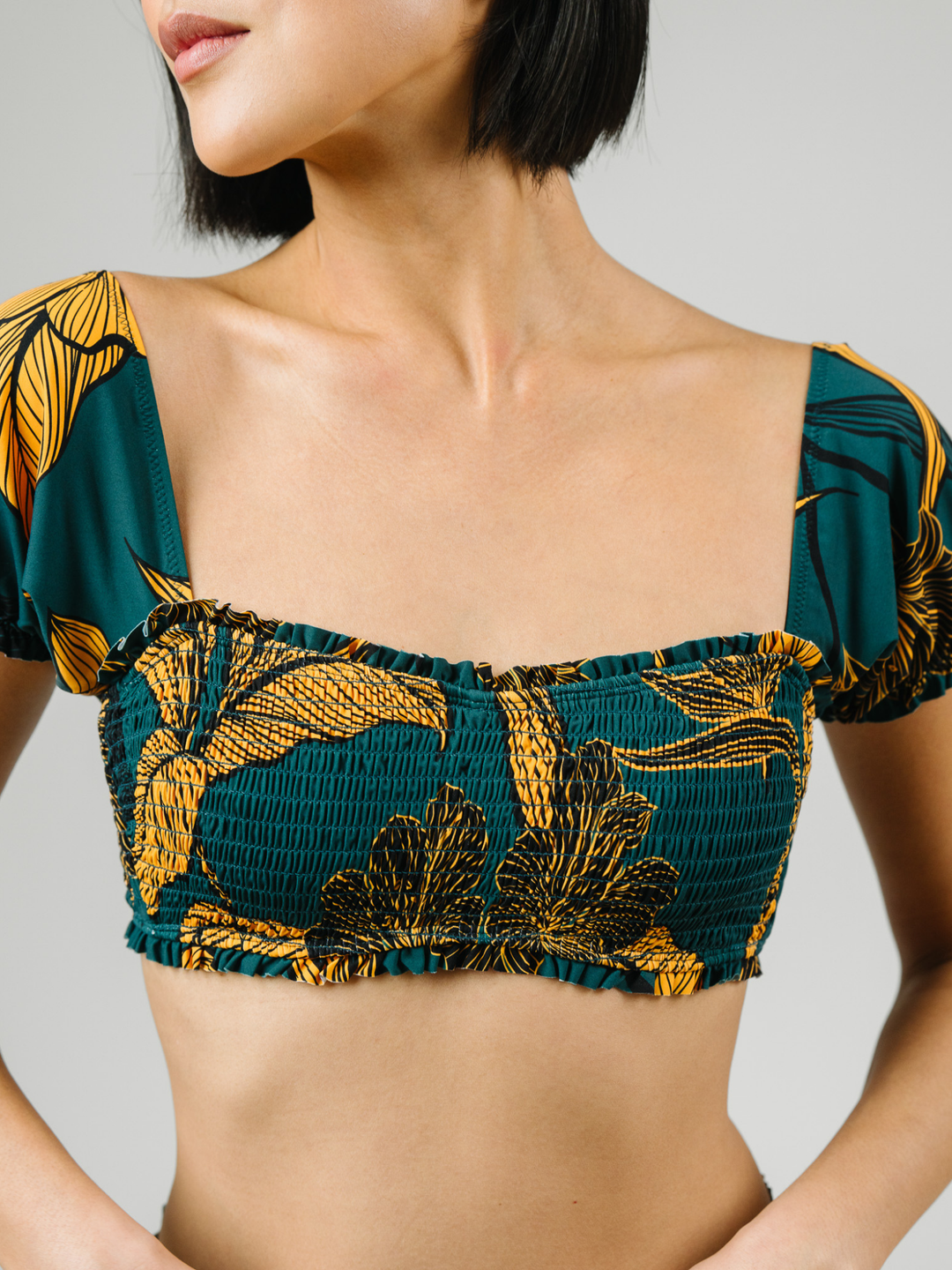 Women's Emerald Enchantment Underwire Bikini Top with Sleeves – women's swimwear, Worn by a model in studio, up close view of smocking